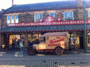 An old co-op shop with a Newcastle Breweries van parked outside.